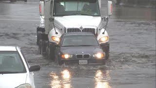 Big rig helps push car trapped in Oakland floodwaters [upl. by Acirtal]